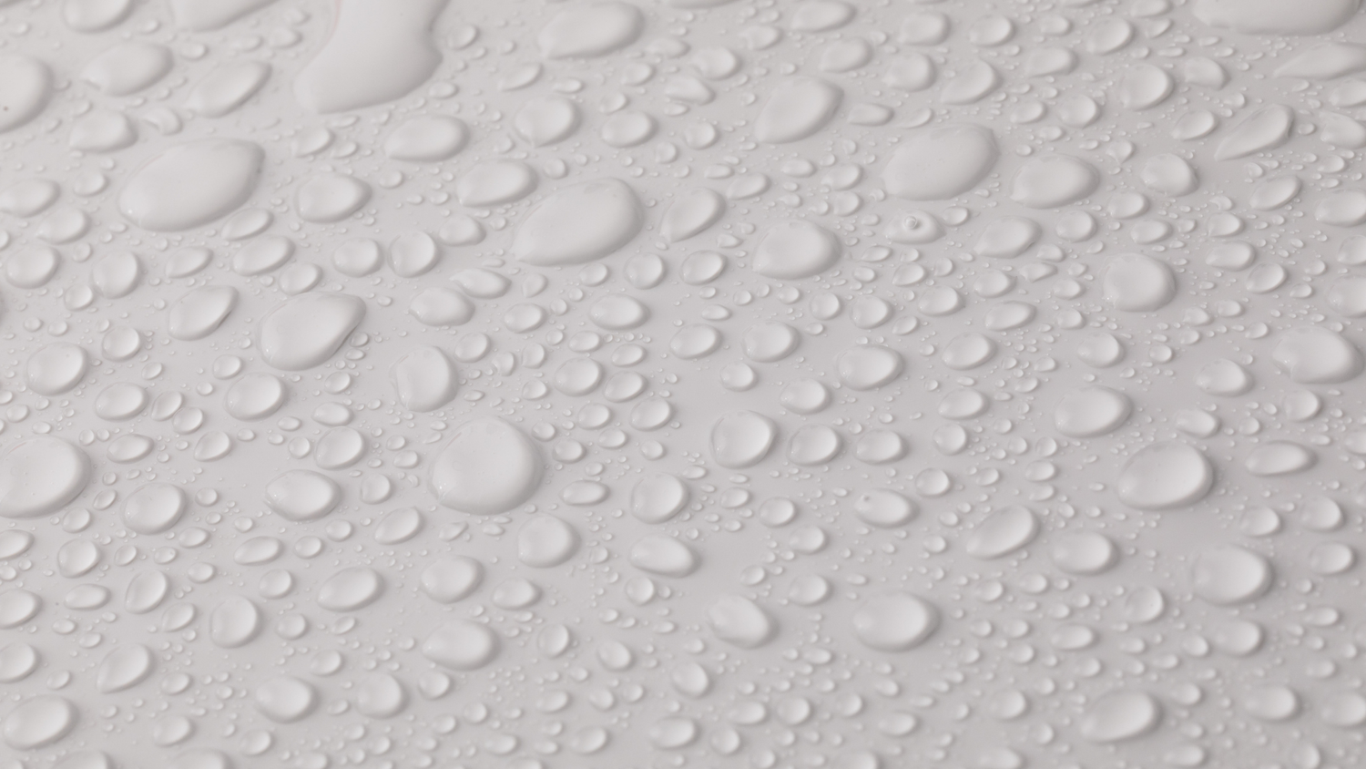 Close-up of water droplets beading on eco-friendly waterproof paper