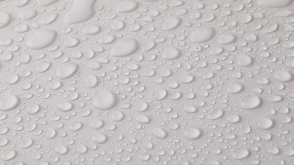 Close-up of water droplets beading on eco-friendly waterproof paper
