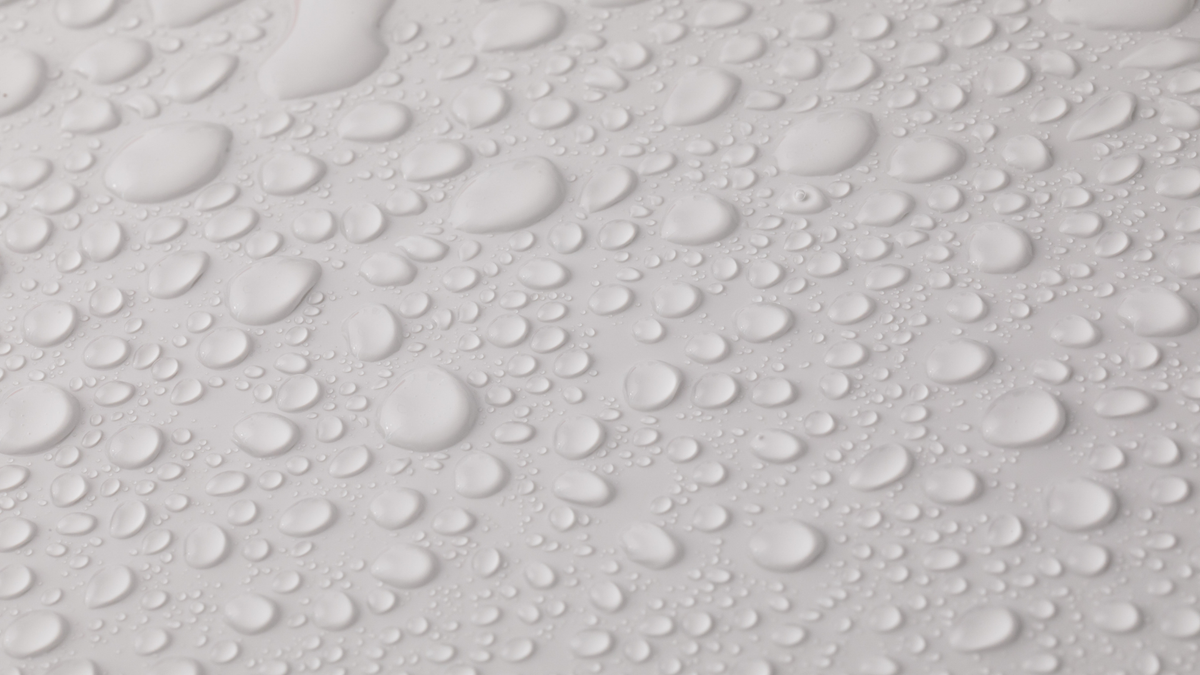 Close-up of water droplets beading on eco-friendly waterproof paper