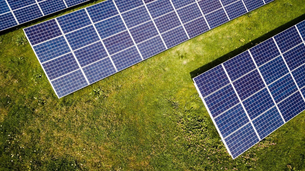 Solar Panels on a Large Grass Field 